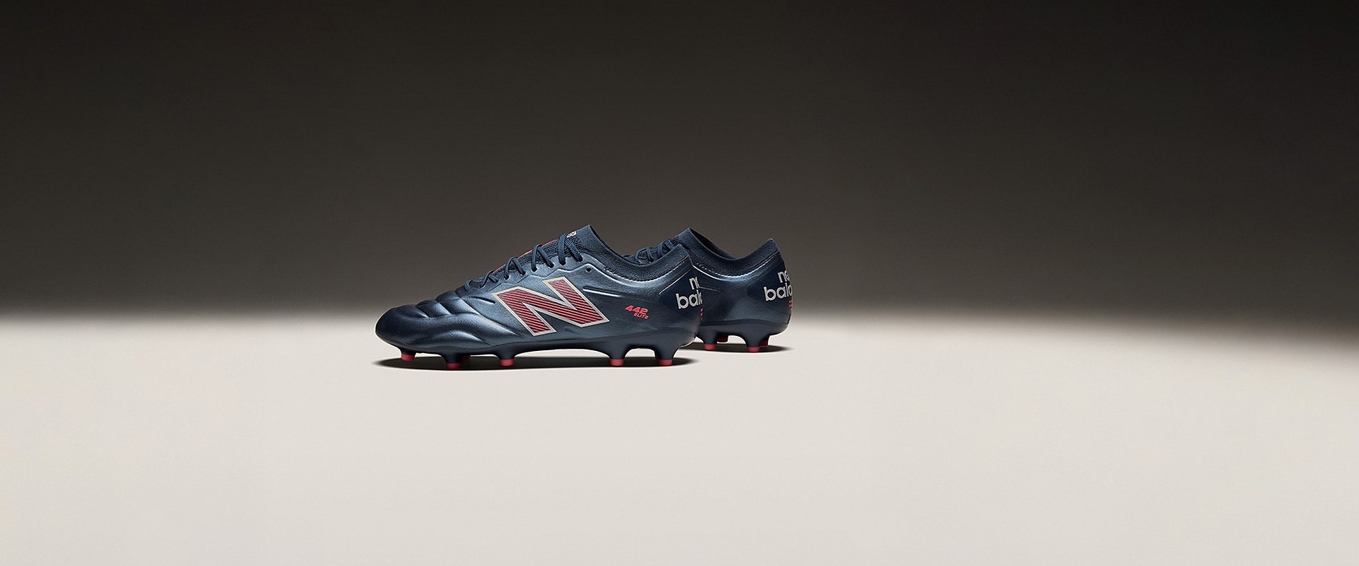 New Balance 442 Elite Firm Ground - Navy/Orange - Adult Cleats |