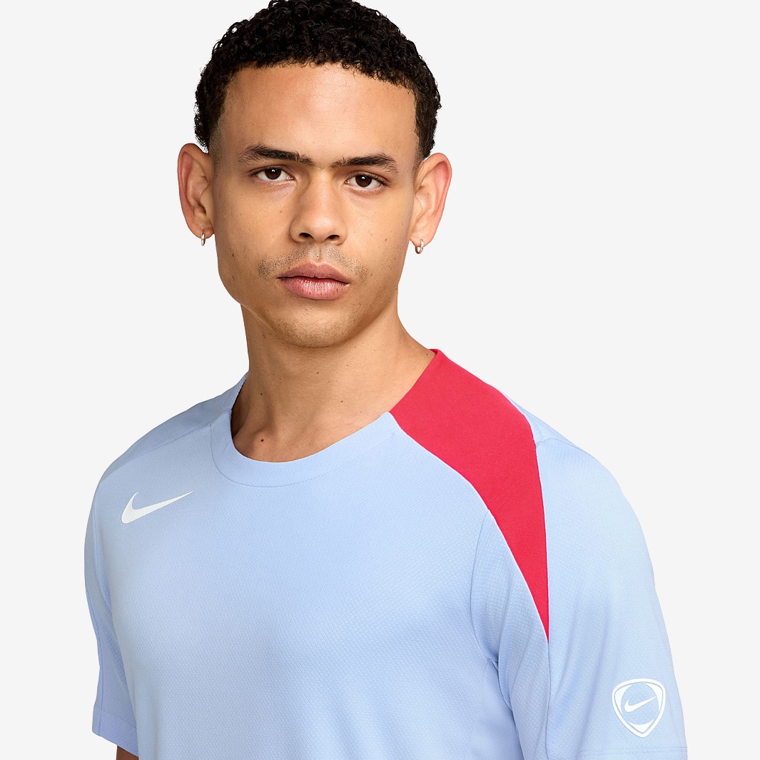 white and bright crimson nike shirt